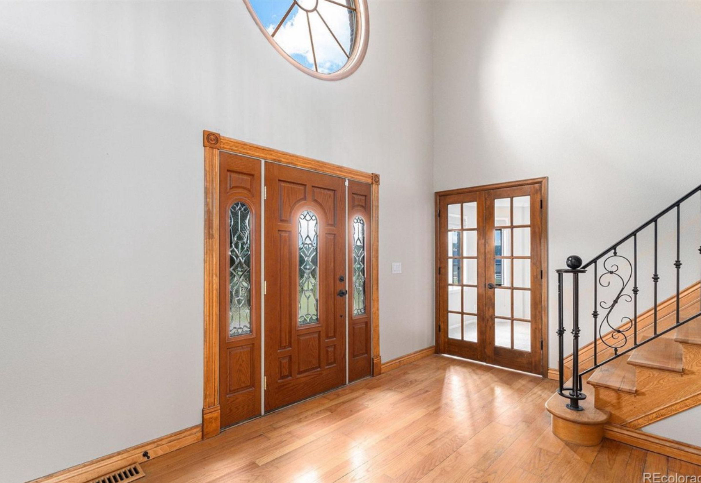 Foyer with leaded glass door and staircase