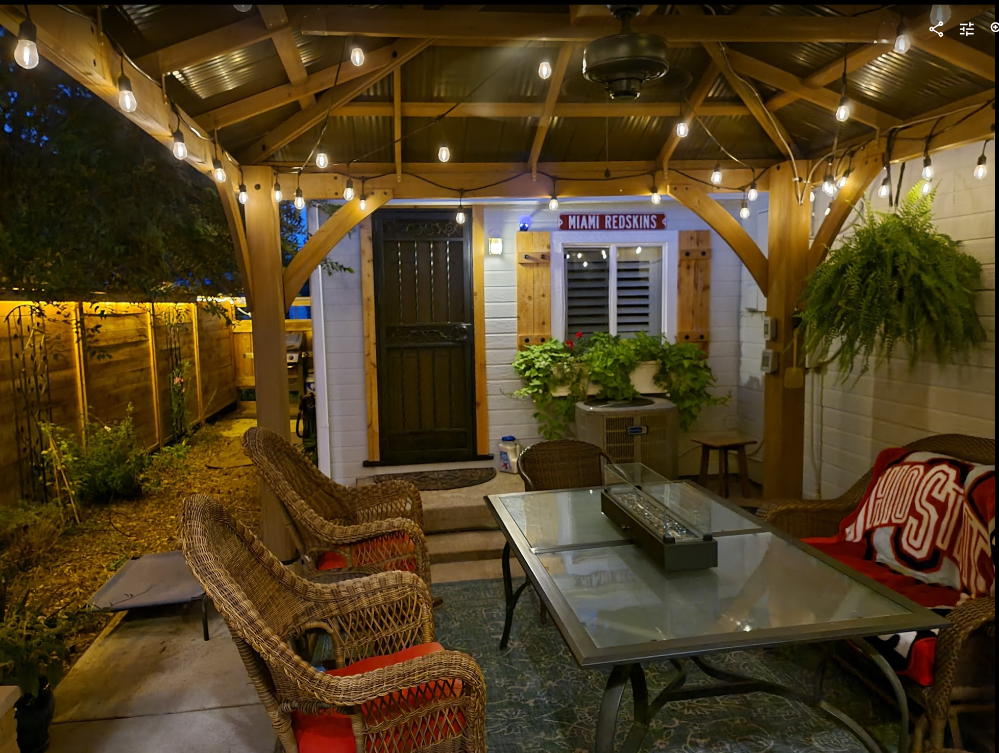Pergola with string lights and fire table