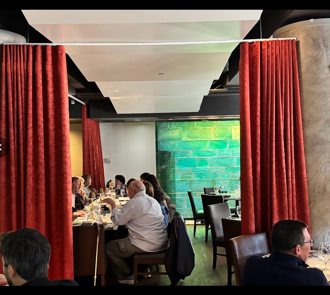 Restaurant interior with red velvet and green tile